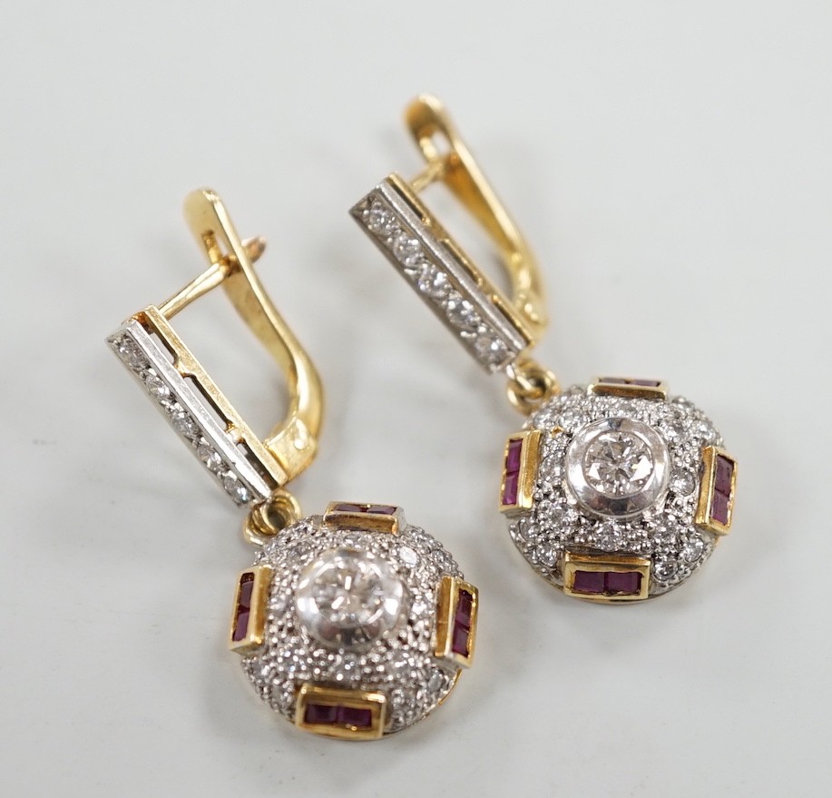 A modern pair of yellow metal, square cut ruby and round cut diamond set circular cluster drop earrings, 30mm, gross weight 8.4 grams.